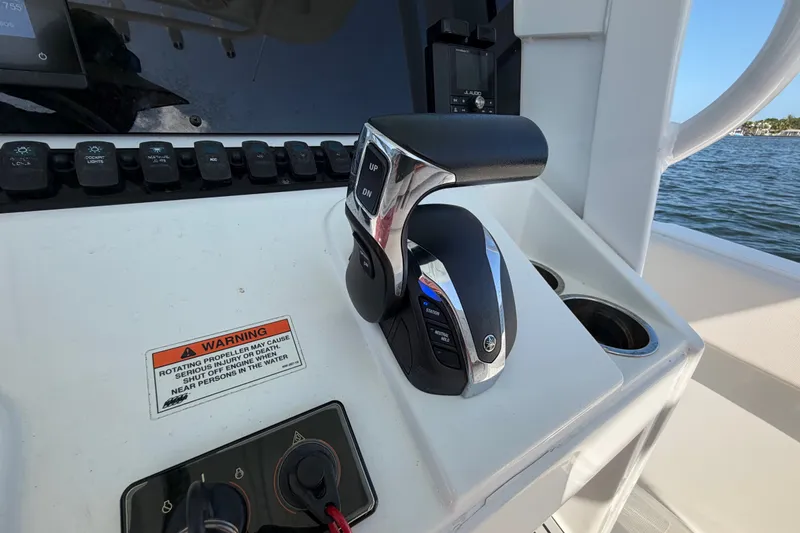 Slide: The Image of Control panel of 2022 Sea Hunt Ultra 239SE boat with throttle and warning label. - 22