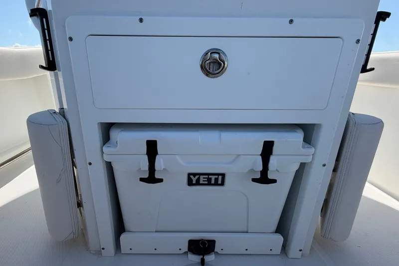Slide: The Image of 2022 Sea Hunt Ultra 239SE boat with Yeti cooler storage compartment. - 50