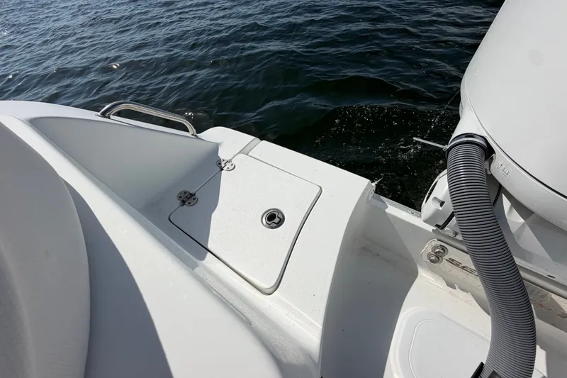 Slide: The Image of 2022 Sea Hunt Ultra 239SE boat deck with water view and engine detail. - 46