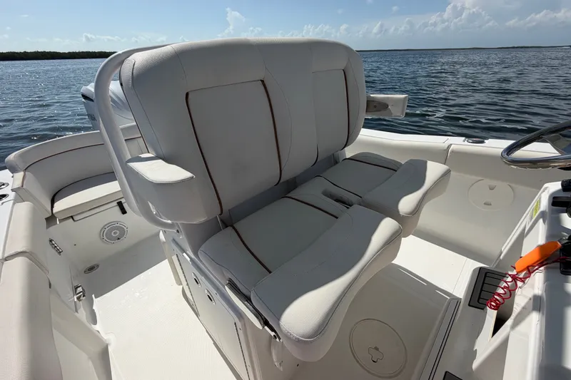 Slide: The Image of 2022 Sea Hunt Ultra 239SE boat interior with comfortable seating and steering wheel. - 34