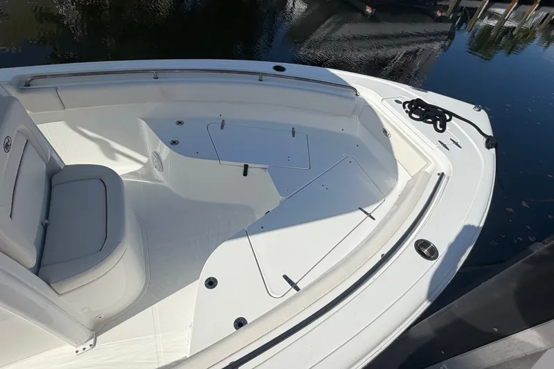 Slide: The Image of 2022 Sea Hunt Ultra 239SE boat interior with seating and storage compartments. - 51
