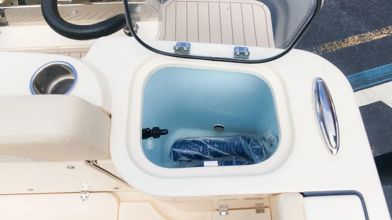 Slide: The Image of An open storage compartment on a Scout 260 LXF boat, featuring a blue interior and accessories. - 14