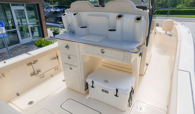 Slide: The Image of The image shows the cockpit of a Scout 260 LXF boat with storage and a cooler. - 6