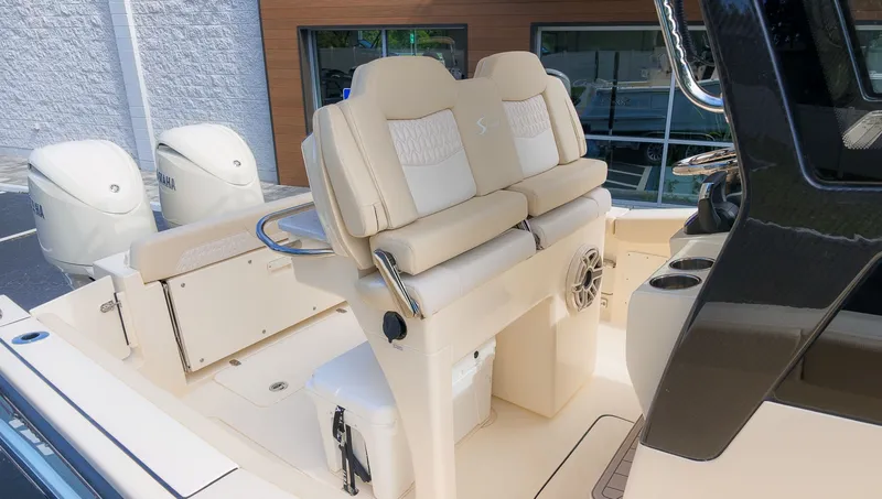 Slide: The Image of The image shows the cockpit of a Scout 260 LXF boat with beige seats and two engines. - 7
