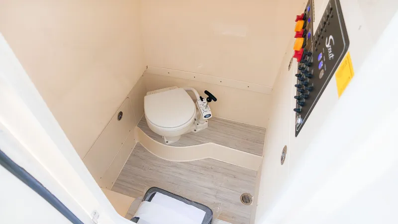Slide: The Image of Interior view of a boat with a toilet and a control panel on the wall. - 21