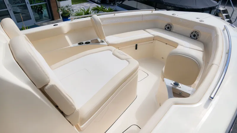 Slide: The Image of The image shows the interior of a 2027 Scout 260 LXF boat with beige upholstery. - 8