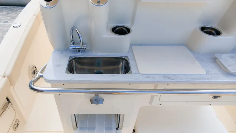 Slide: The Image of The 2027 Scout 260 LXF features a sleek onboard kitchenette with a sink and countertop. - 14