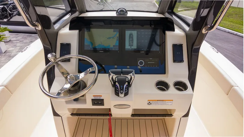 Slide: The Image of The image shows the cockpit of a 2027 Scout 260 LXF boat with a modern helm station. - 14