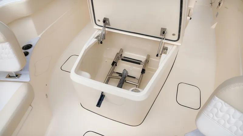 Slide: The Image of The image shows the storage compartment of a Scout 260 LXF boat with a ladder inside. - 19