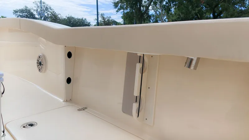 Slide: The Image of The image shows the interior of a Scout 260 LXF boat with cream-colored upholstery and speakers. - 8