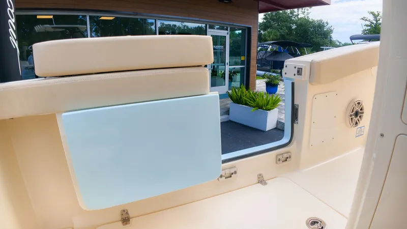 Slide: The Image of The image shows the interior of a 2027 Scout 260 LXF boat with beige upholstery. - 21