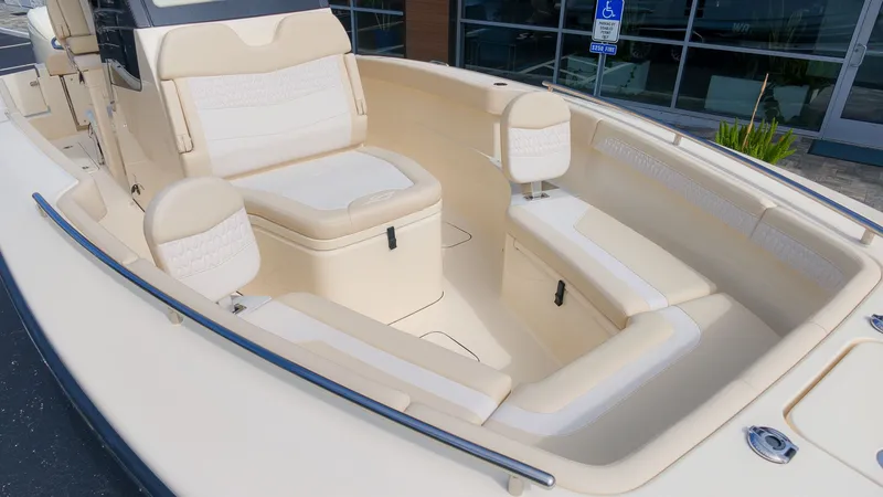 Slide: The Image of The image shows the cockpit of a 2027 Scout 260 LXF boat with beige upholstery. - 7