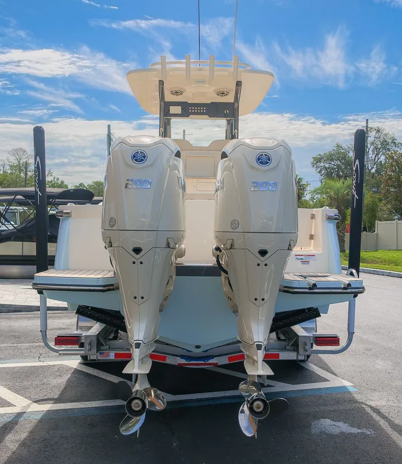 Slide: The Image of The image shows the rear of a Scout 260 LXF boat with two outboard engines. - 2