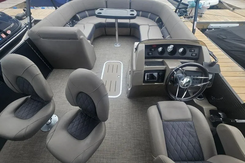 Slide: The Image of 2019 Bennington SX 23 SPDXP pontoon boat interior with plush seating and modern dashboard. - 6