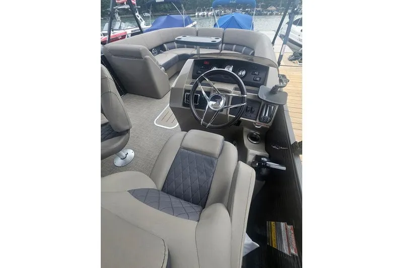 Slide: The Image of 2019 Bennington SX 23 SPDXP boat interior with steering wheel and seating. - 12