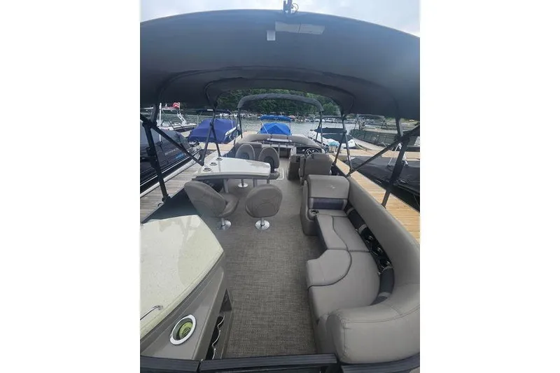 Slide: The Image of 2019 Bennington SX 23 SPDXP pontoon boat interior with seating and table setup. - 4