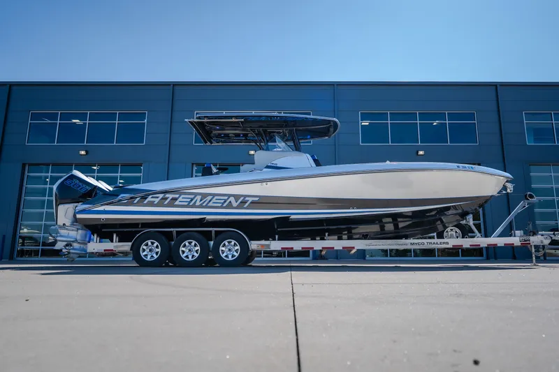 The Image of 2022 Statement 350 Open boat on trailer, parked outside modern building. - 2