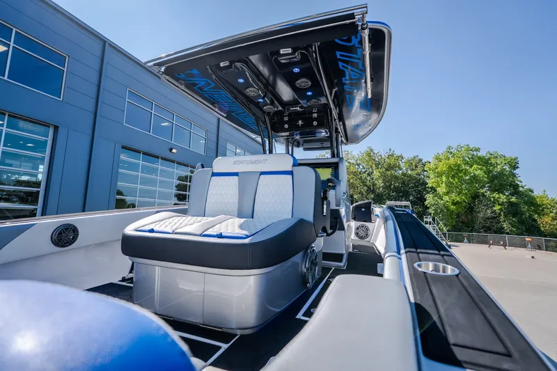 Slide: The Image of 2022 Statement 350 Open boat with sleek seating and modern design near a building. - 17