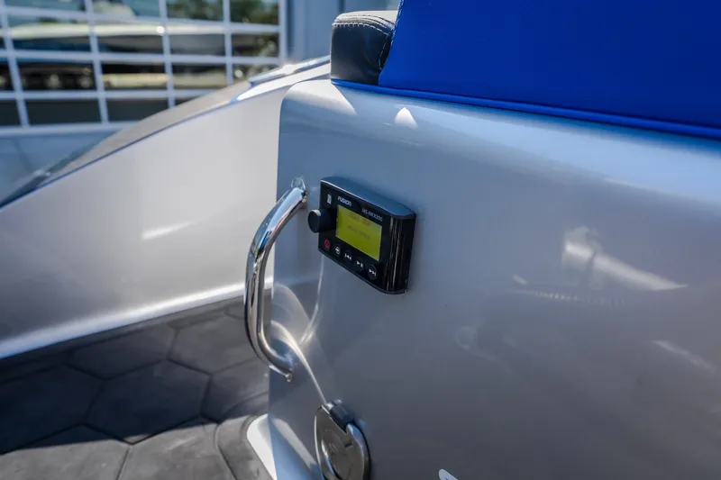 Slide: The Image of 2022 Statement 350 Open boat interior with audio control panel and blue seating. - 19