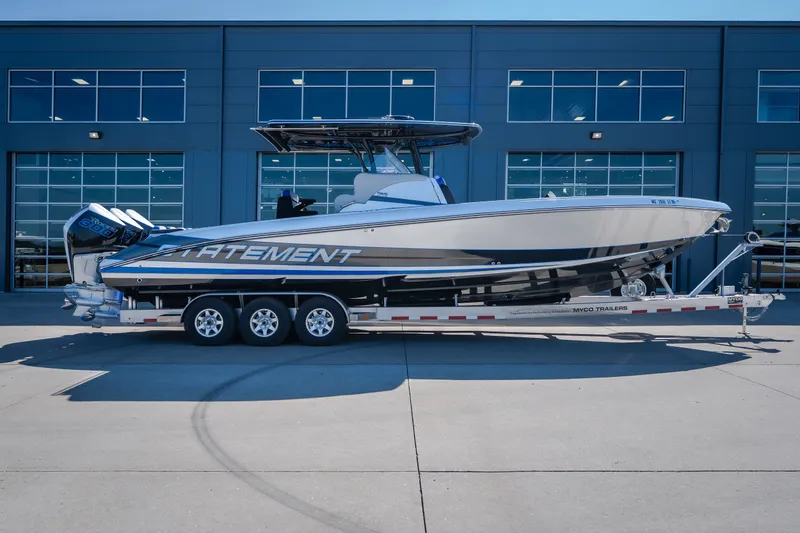 Slide: The Image of 2022 Statement 350 Open boat on trailer, parked outside a modern building. - 15
