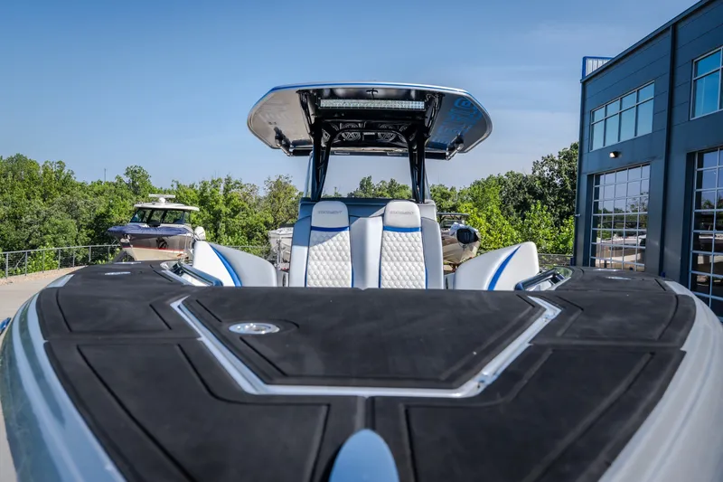 Slide: The Image of 2022 Statement 350 Open boat with sleek design, docked near modern building. - 52