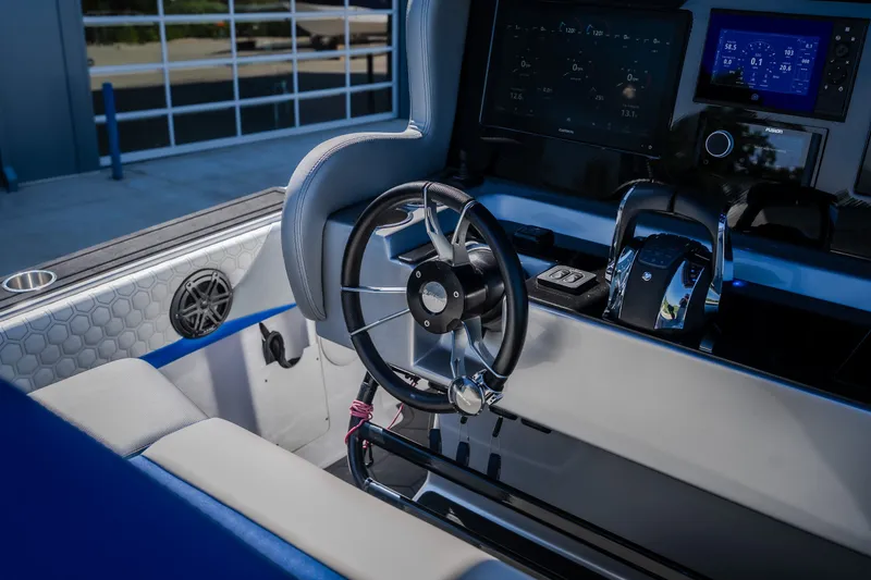 Slide: The Image of Interior of 2022 Statement 350 Open boat, featuring modern steering and control panel. - 27