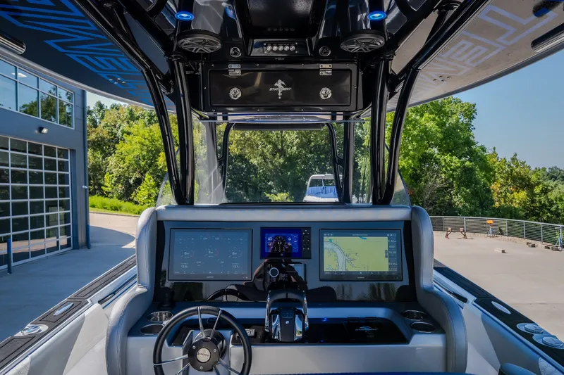 Slide: The Image of Cockpit view of 2022 Statement 350 Open boat with advanced navigation displays. - 26