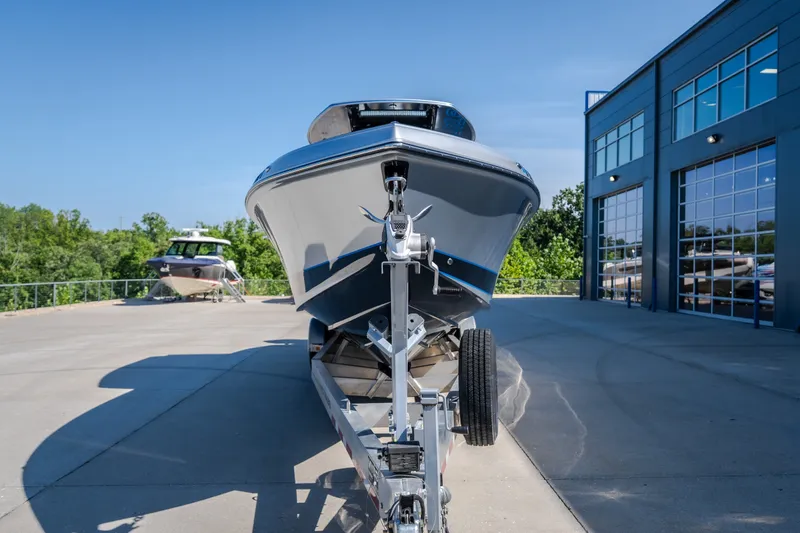 Slide: The Image of 2022 Statement 350 Open boat on trailer outside modern building. - 57