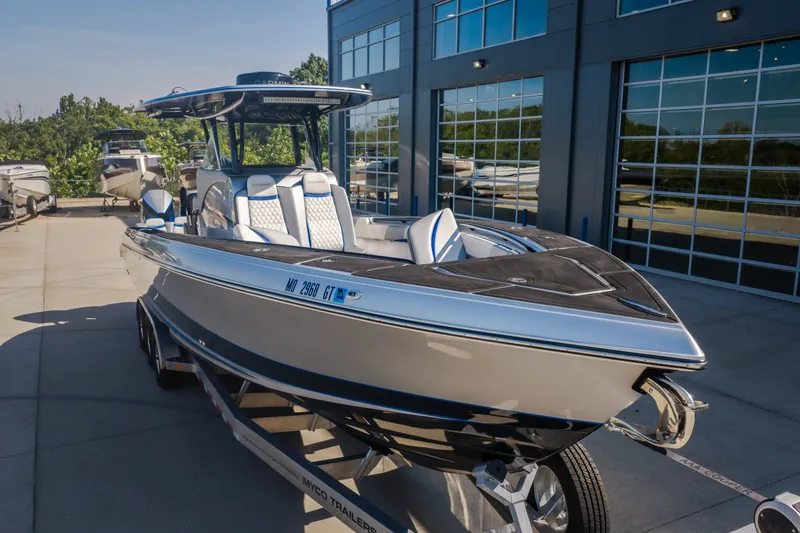 Slide: The Image of 2022 Statement 350 Open boat on trailer outside modern building. - 50