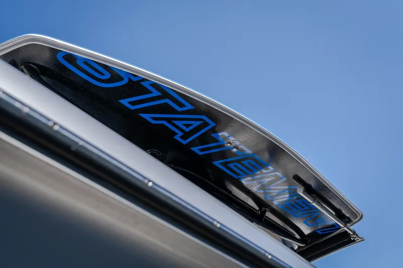 Slide: The Image of 2022 Statement 350 Open boat detail with blue logo against clear sky. - 55