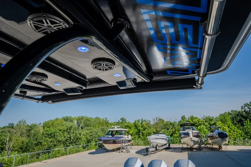 Slide: The Image of 2022 Statement 350 Open boat with illuminated speakers, docked alongside other boats. - 48