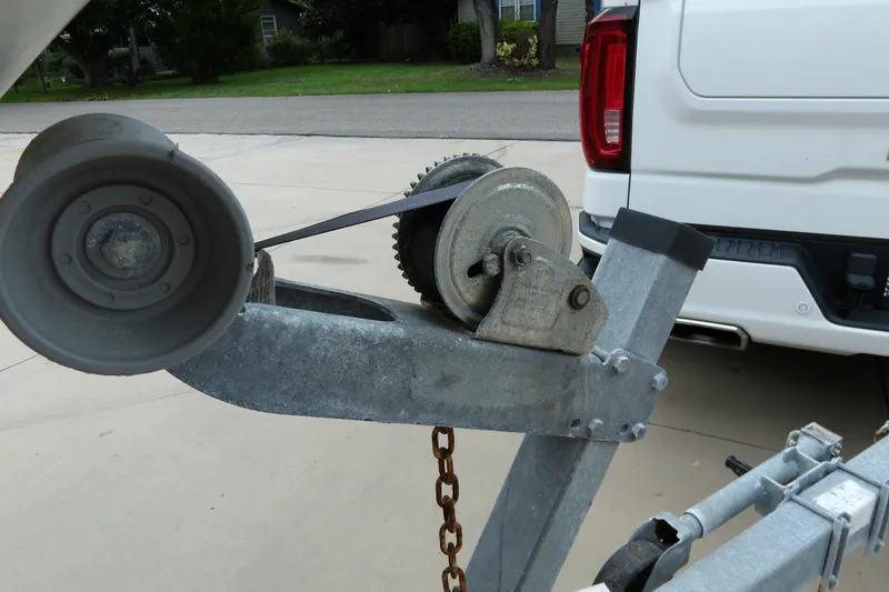 Slide: The Image of Trailer winch for 1991 Boston Whaler SL16 boat, parked on a driveway. - 22