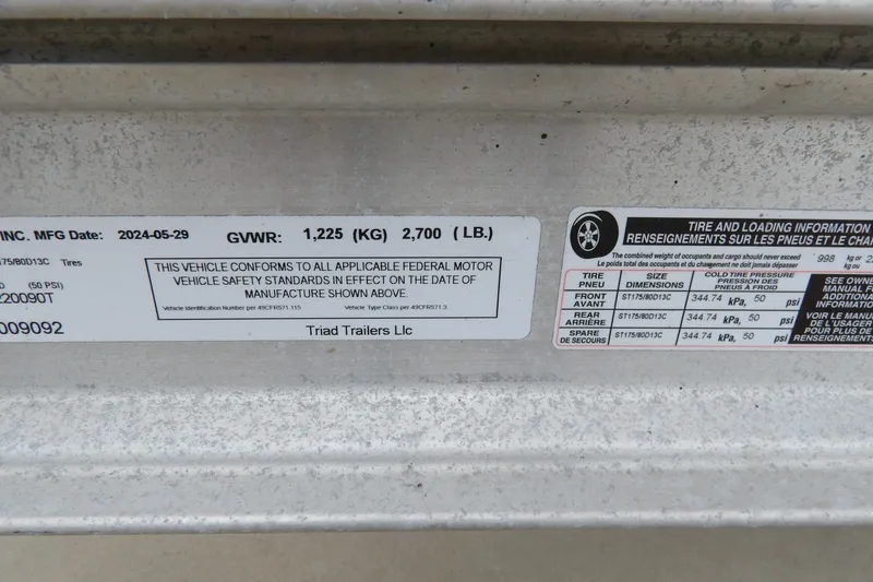 Slide: The Image of Label on a 1991 Boston Whaler SL16 trailer by Triad Trailers, showing tire and loading information. - 23
