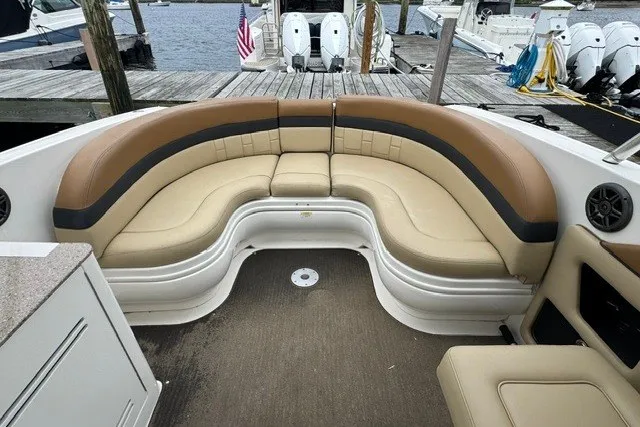 Slide: The Image of Luxurious seating on a 2016 Sea Ray 300 SLX boat docked at a marina. - 14