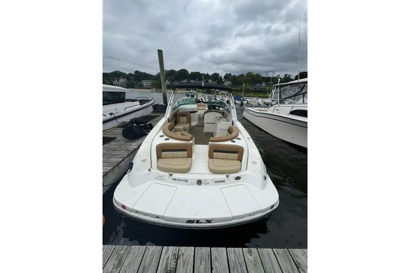 Slide: The Image of 2016 Sea Ray 300 SLX boat docked, featuring spacious seating and sleek design. - 7
