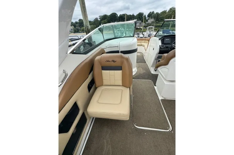 Slide: The Image of 2016 Sea Ray 300 SLX boat interior with tan and cream seating. - 11