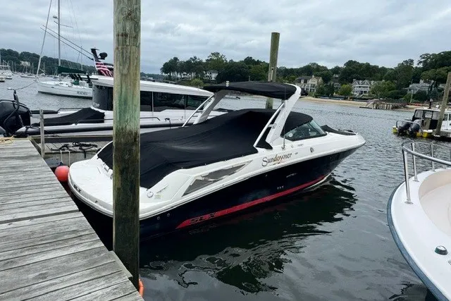 Slide: The Image of 2016 Sea Ray 300 SLX boat docked at marina with cover on. - 1