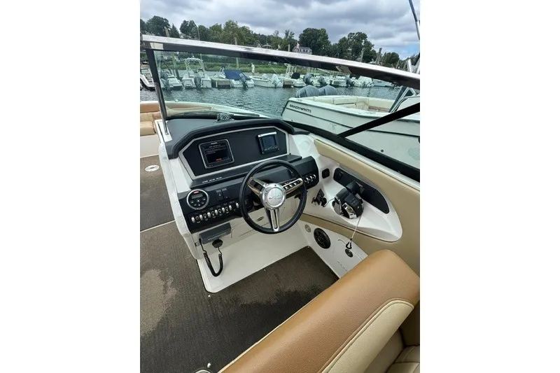 Slide: The Image of 2016 Sea Ray 300 SLX boat cockpit with steering wheel and control panel. - 20
