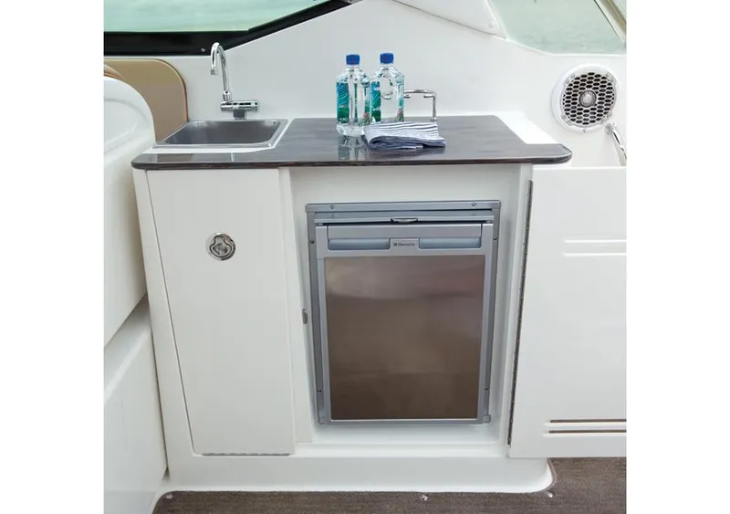 Slide: The Image of Manufacturer Provided Image: 2016 Sea Ray 300 SLX boat kitchenette with sink, mini-fridge, and countertop. - 4