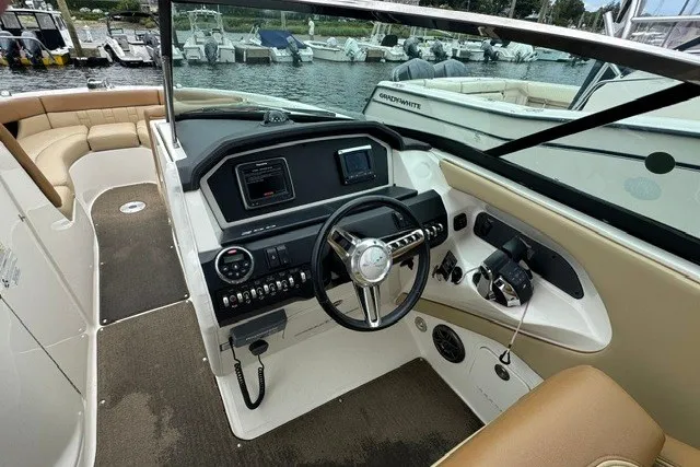 Slide: The Image of Cockpit view of a 2016 Sea Ray 300 SLX boat with modern controls and steering. - 21