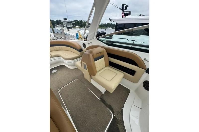 Slide: The Image of Interior of a 2016 Sea Ray 300 SLX boat with tan seating and carpeted floor. - 18