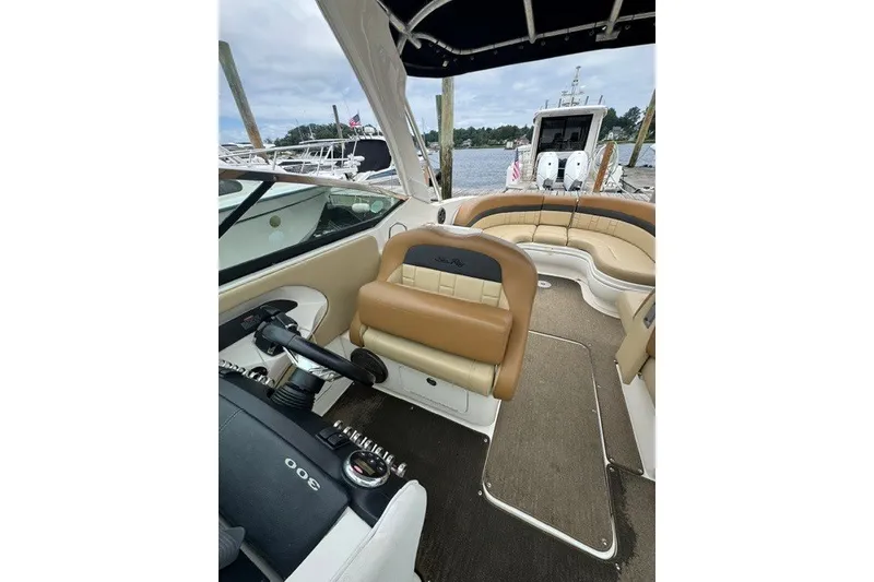 Slide: The Image of Interior view of a 2016 Sea Ray 300 SLX boat with tan seating and steering wheel. - 17