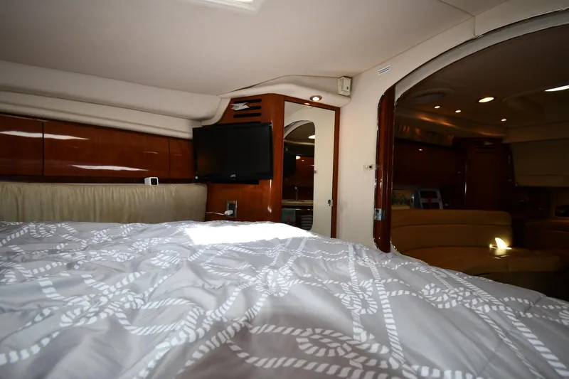 Slide: The Image of Interior cabin of a 2004 Sea Ray 360 Sundancer yacht, featuring a cozy bed and modern amenities. - 36
