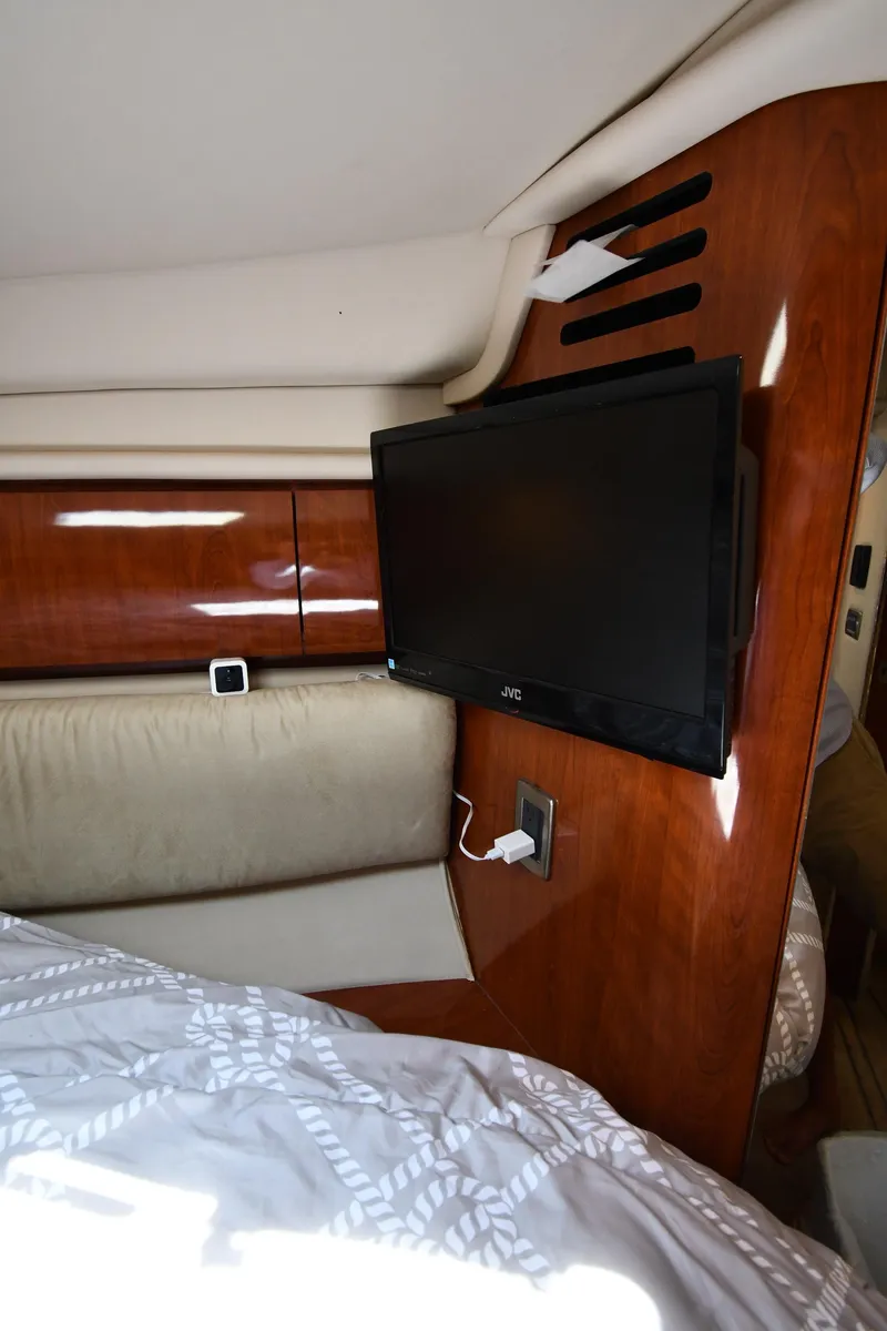 Slide: The Image of 2004 Sea Ray 360 Sundancer cabin interior with TV and wooden paneling. - 37