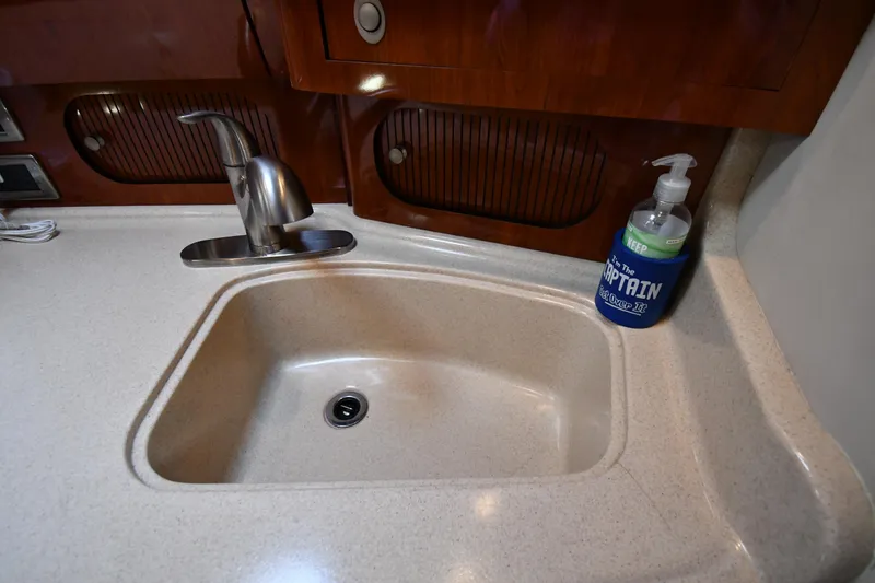 Slide: The Image of 2004 Sea Ray 360 Sundancer kitchen sink with faucet and soap dispenser. - 46
