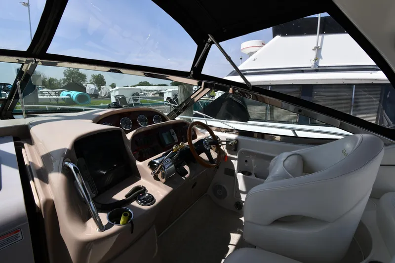 Slide: The Image of 2004 Sea Ray 360 Sundancer helm with steering wheel and control panel. - 14