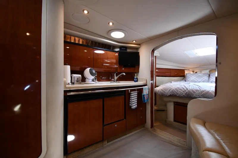 Slide: The Image of 2004 Sea Ray 360 Sundancer interior with kitchen and cozy bedroom. - 40