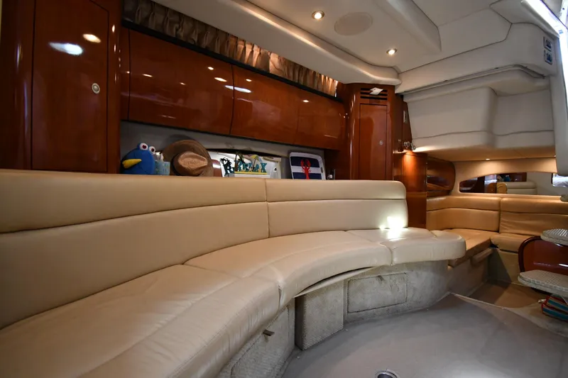 Slide: The Image of Interior of 2004 Sea Ray 360 Sundancer yacht with beige leather seating and wooden cabinets. - 44