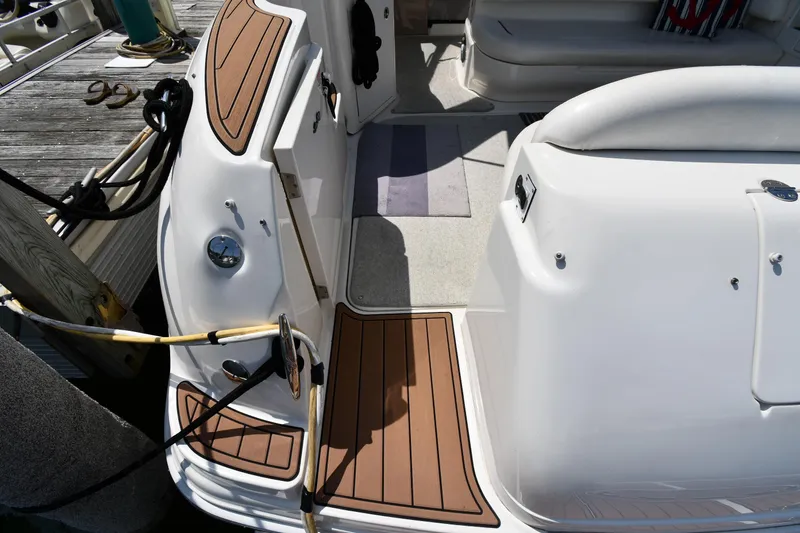 Slide: The Image of 2004 Sea Ray 360 Sundancer boat deck with wood accents and docked at marina. - 24