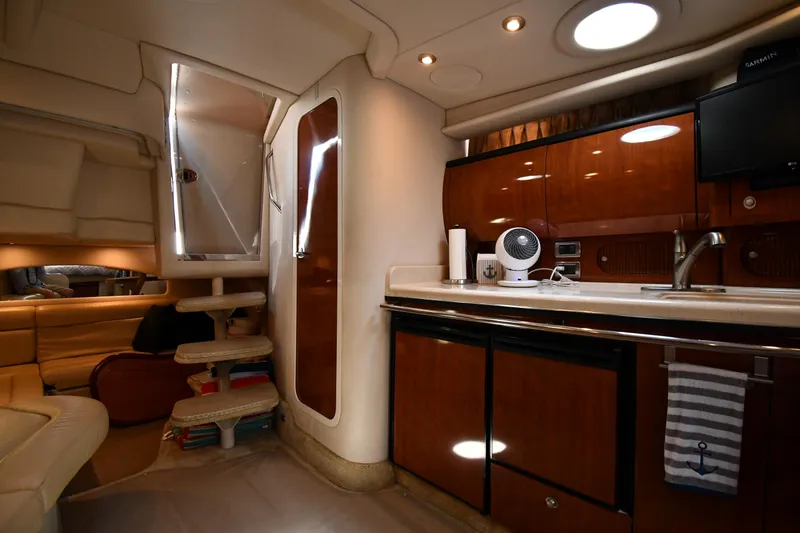 Slide: The Image of Interior of 2004 Sea Ray 360 Sundancer yacht, featuring a modern kitchen and cozy seating area. - 42
